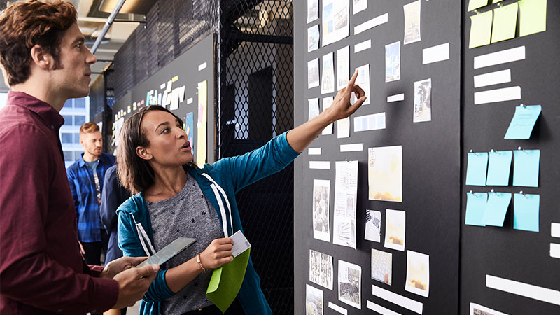 overview-800x450 Man and woman discussing an item on a Scrum Task Board.